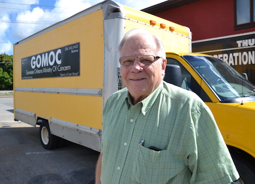 Photo by Tom Rivers: Laverne Bates executive director of the Genesee-Orleans Ministry of Concern, stands by the furniture truck that has been sidelined due to engine trouble, bad brakes and other breakdowns.