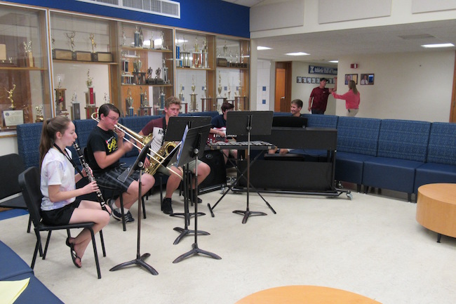 Kendall Jr./Sr. High vocal and instrumental music students provided entertainment during the Open House.  They are seated on new furniture in  the Commons area of the school.