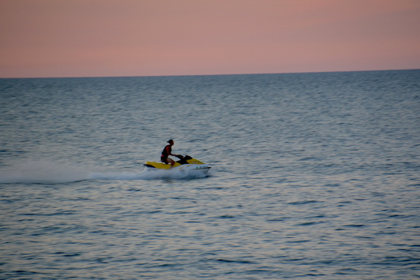 This Jet Ski rider enjoys a trip on Lake Ontario on Sunday evening.