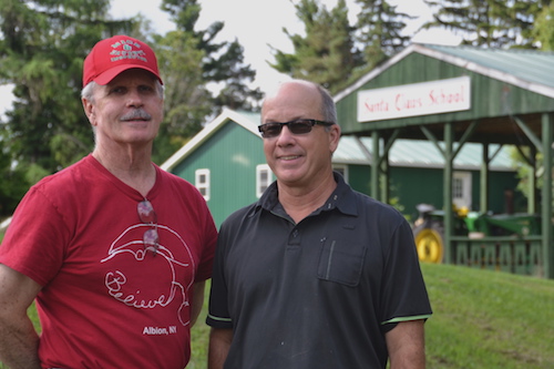 Gary Kent (left), a director for the Albion Betterment Committee, and Bill Downey are pictured by the new sign that Downey installed about two weeks ago at the former Santa Claus School site in Albion.