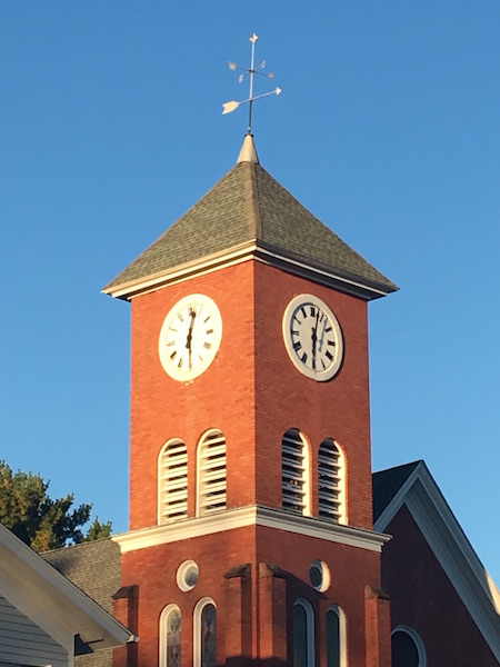 Photo by Tom Rivers: A former United Methodist Church in the Public Square at Holley is pictured recently. The church is now used for apartments. The clock faces were restored last year.