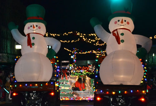 File photo by Tom Rivers: Two giant snowmen greet people on the parade route during the seventh annual Parade of Lights in Medina last Nov. 28. The snowmen were part of a float by Bentley Brothers in Albion. The Sandstone Trust provides some funding to support the parade.