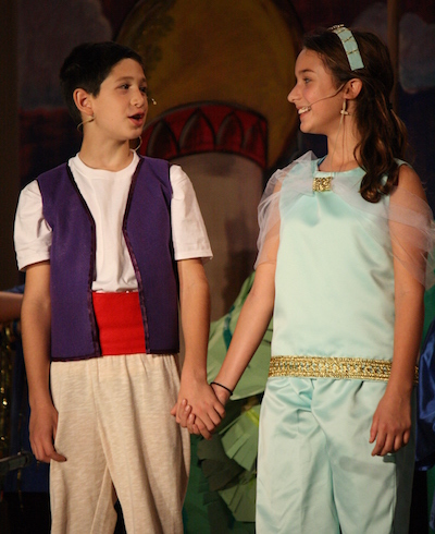 Chris Nettles (Aladdin) and Megan Gates (Jasmine) sing a song together.