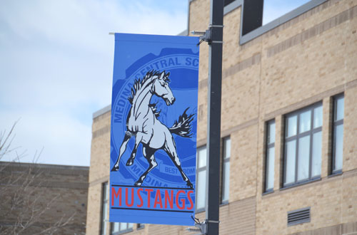 Photo by Tom Rivers: A Medina Mustang banner hangs outside on the district campus.