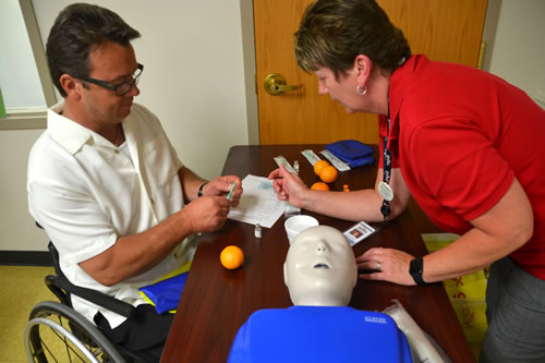 Sheriff Randy Bower receives training in using Narcan from Diana Fulcomer of GCASA. About 20 people received the training on July 13. Narcan can help someone suffering an overdose.