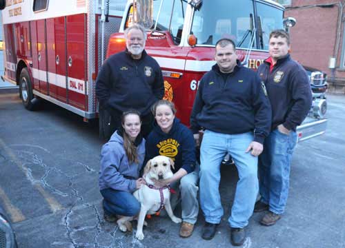 Photo by Tom Rivers – Holley firefighters are pictured on Feb. 27 with Alexandria Disque, second from left, and a dog Sadie, as well as Sadie’s owner Cassie Wolfanger, left. Disque and Sadie were rescued this afternoon after being swept in a tunnel on Sandy Creek that goes under the Erie Canal. The firefighters were on a boat that went into the dark tunnel. Pictured from left in back include Fran Gaylord, Harris Reed and Justin McMillon.